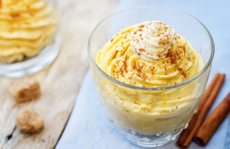  pumpkin spice cheesecake mousse on a white wood background. toning. selective focus