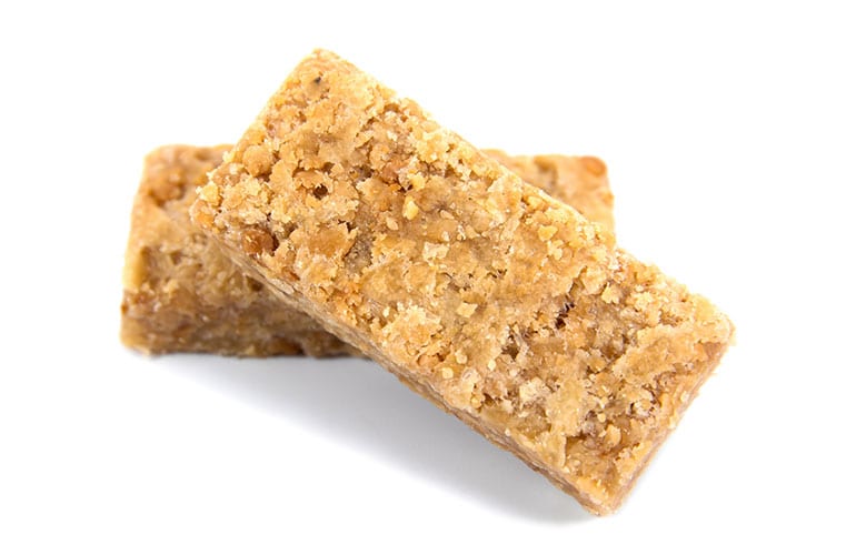 It is two stack of caramel ground peanuts bar isolated on white background.