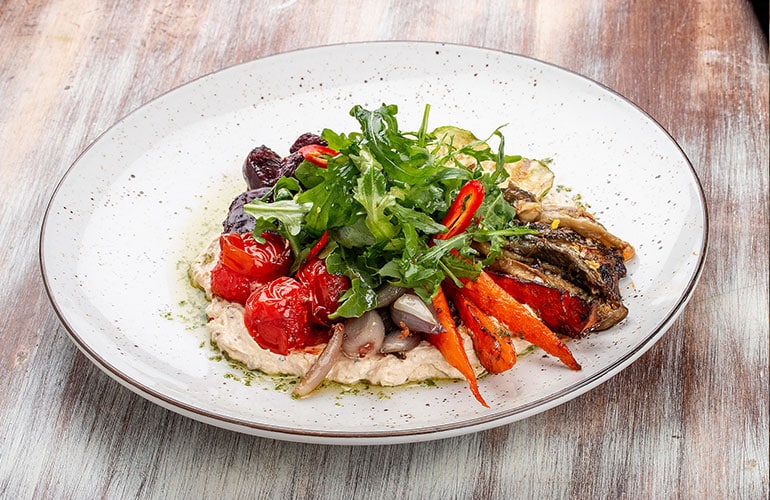 roasted vegetables over hummus