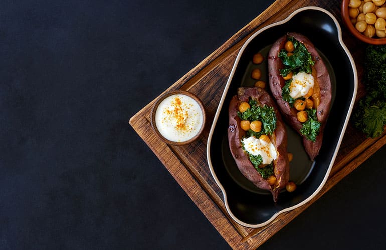 Baked sweet potato filled with kale and chickpeas