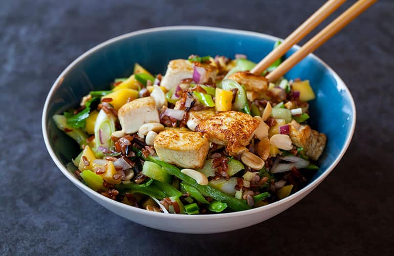 Vegan salad with crispy tofu, red and wild rice and mango