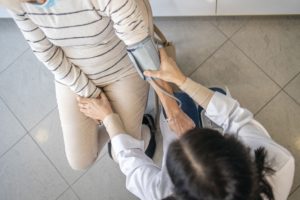 Physician taking blood pressure of a patient