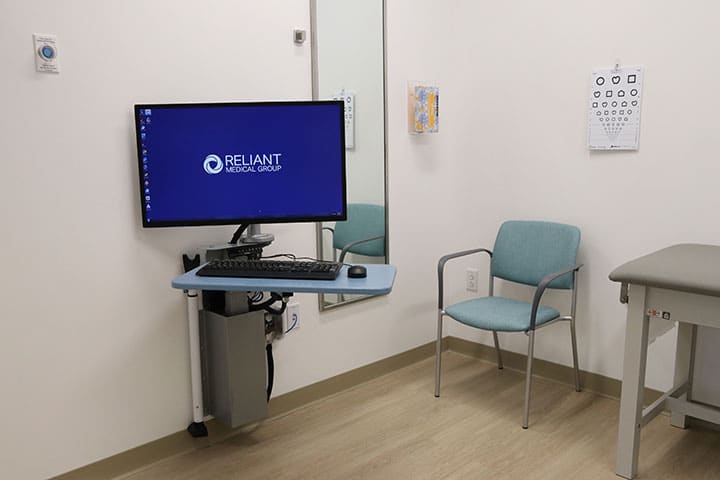 Computer screen in the exam room with Reliant logo on it