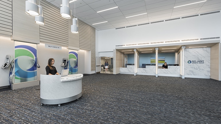 Lobby with a person sitting at a small desk