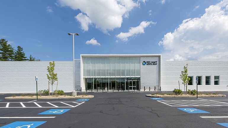 Exterior of large medical building with large parking lot