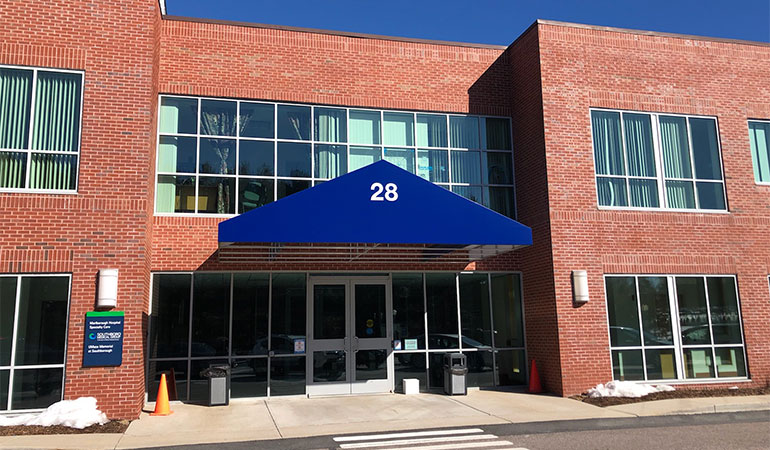 Brick building with awning that says 28