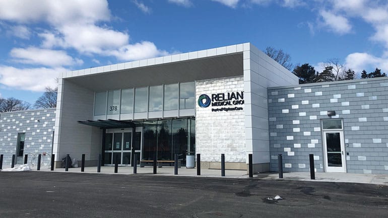 Exterior of a modern building with Reliant logo
