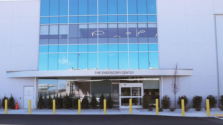 Building with glass front and sign that reads 