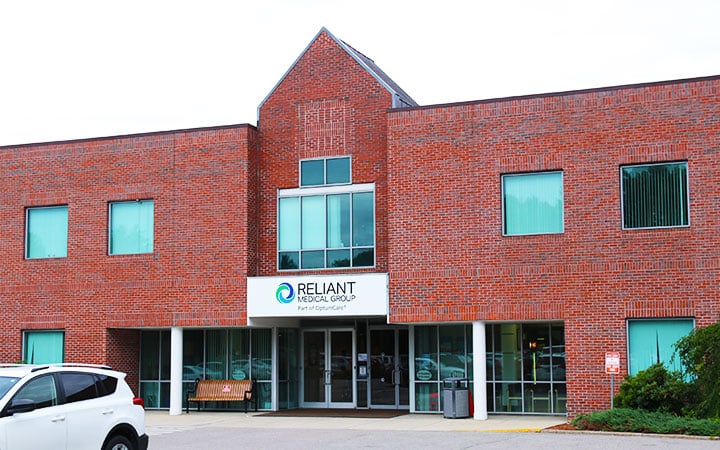 Exterior of a brick building with Reliant Medical Group sign on the front